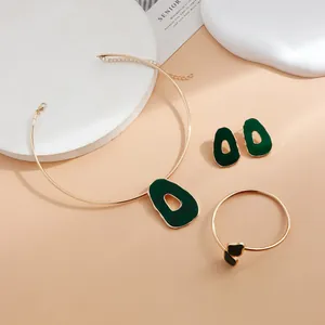 Elegant gold-tone jewelry set with dark green irregular hollow pendants and choker