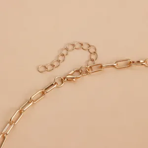 Close-up detail of a vintage gold geometric link necklace with a secure lobster clasp.