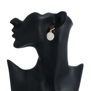 Elegant geometric round dripping oil drop earrings on a black mannequin stand.