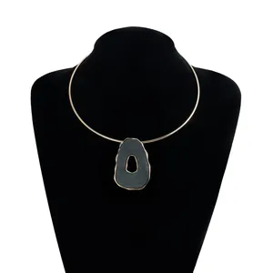 Close-up of a retro gold-tone choker featuring a unique irregular hollow pendant.