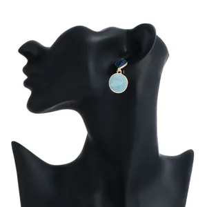 Detailed view of blue enamel geometric round drop earrings displayed on a black mannequin.