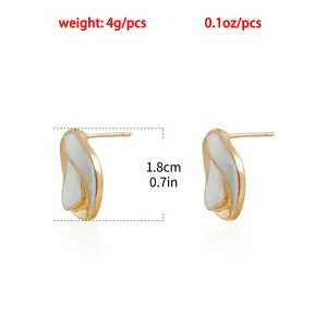 Detail of French style twisted gold earrings with white enamel inlay and dimensions