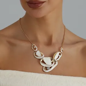 Close-up of a model wearing an elegant gold necklace with white enamel pleat pendants