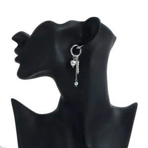 Elegant silver heart tassel drop earring displayed on a black mannequin profile