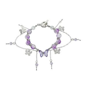 Bracelet en perles violettes avec papillons en cristal et glands en chaîne argentée