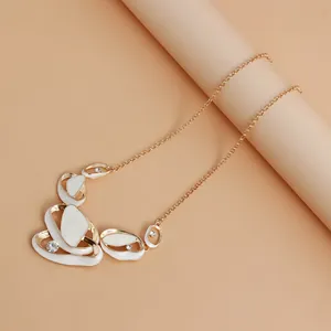 Elegant French style fold cutout necklace with white enamel pieces and gold chain detail