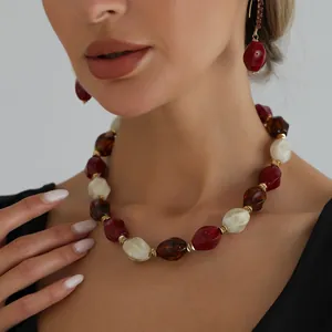 Detail view of a vintage multicolored acrylic beaded necklace on a model