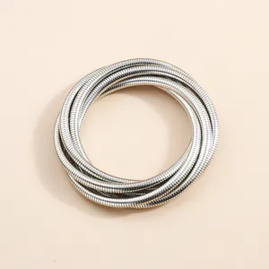Detailed view of the silver-toned multi-layered snake chain coil bracelet texture.