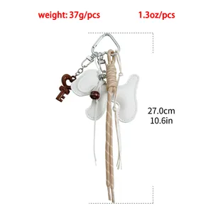 Macro view of white leather dog keychain with dimensions showing 27cm length and 37g weight