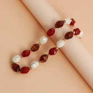 Close-up view of a retro acrylic color-block beaded necklace with stylish gold accents.