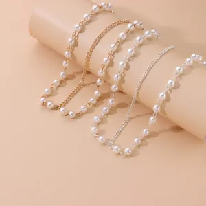 Detailed view of handmade pearl hair chains featuring gold and silver link designs