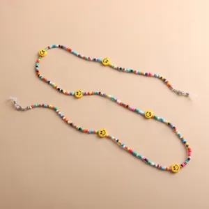 Detailed view of a colorful acrylic bead eyeglasses chain featuring yellow smiley faces.