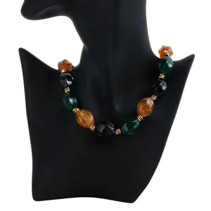 Close-up of retro acrylic beaded necklace with colorful beads on a black mannequin stand