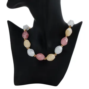 Detailed view of a retro multi-colored acrylic beaded necklace displayed on a black mannequin