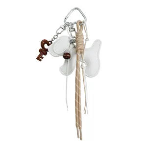 Creative white puppy keychain with woven tan rope and key charm for bag accessory