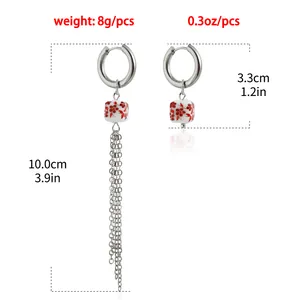 Detailed view of asymmetric earrings with 10cm long tassel and 3.3cm hoop length