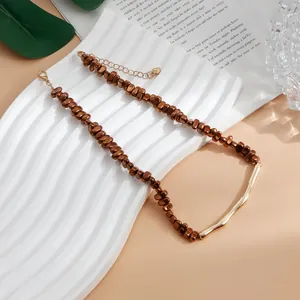 Close-up of Maillard brown beaded necklace with vintage gold-tone lava bar