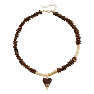 Maillard brown beaded necklace with a molten heart pendant in vintage gold finish