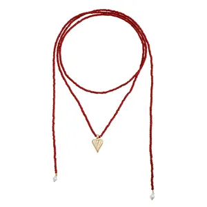 Long red seed bead necklace with a textured gold heart pendant and pearl accents