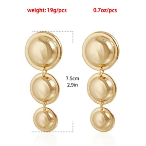 Detailed size and weight view of gold oversized metallic triple round drop earrings.