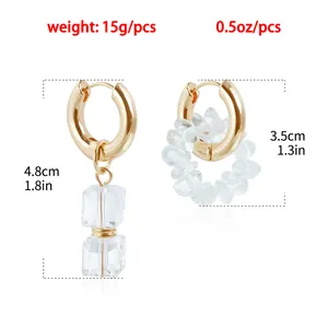 Detailed view of asymmetric clear crystal gold hoop earrings with weight and dimensions