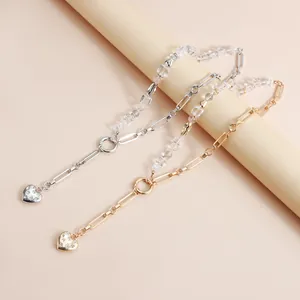 Detailed close-up showing heart charms and crystal beads on gold and silver Y-shaped necklaces