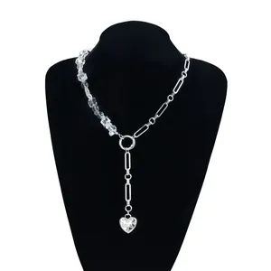 Macro view of the elegant silver Y-shaped necklace featuring a crystal heart pendant
