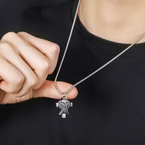 Detailed view of titanium steel cross necklace with angel wings pendant for men.