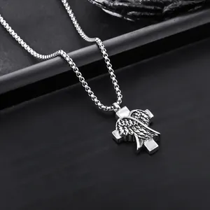 Close-up detail of titanium steel cross pendant featuring intricate angel wing texture