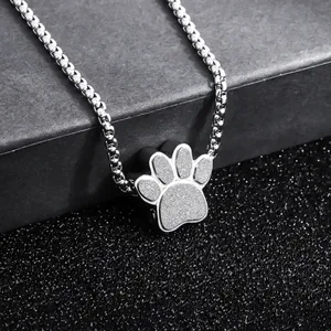 Close-up detail of a paw-shaped titanium steel perfume pendant with textured finish