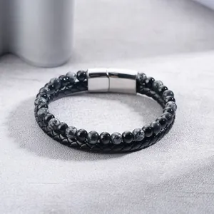 Detailed shot of double-layered black braided leather bracelet with natural stone beads