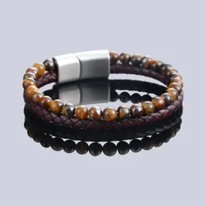 Detailed view of yellow Tiger Eye beads and braided leather bracelet with magnetic clasp
