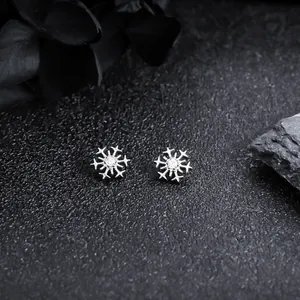 Close-up macro view of F136 titanium snowflake stud earring with clear zircon stone