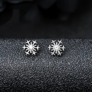 Macro detail of F136 titanium snowflake stud with zircon inlay for piercing.