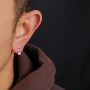 Detailansicht eines F136 Titan Hufeisenohrrings mit Zirkonia-Steckern an einem Männerohr