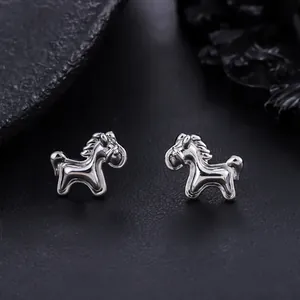 Detailed close-up of polished silver horse stud earrings with a 3D animal design