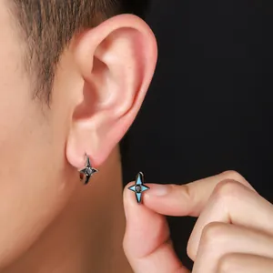 Macro view showing the intricate detail of four-pointed star zircon earrings on ear