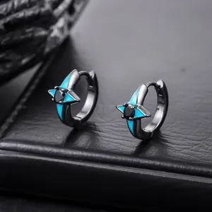 Detailed macro view of black four-pointed star zircon hoop earrings with blue accents.