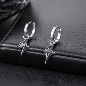 Detailed close-up of silver four-pointed star hoop earrings with black center stones