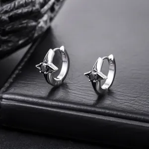 Detailed view of silver hoop earrings featuring a four-pointed star with black zircon