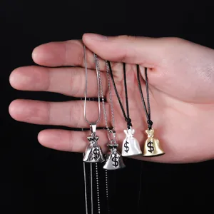 Close-up of four money bag pendants in gold and silver finishes on varied chains.