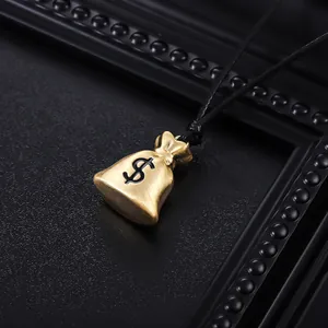 Detailed view of a golden money bag pendant with dollar sign on a black cord.