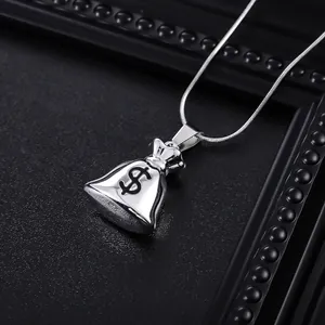 Detailed macro view of a silver money bag pendant with black dollar sign and snake chain