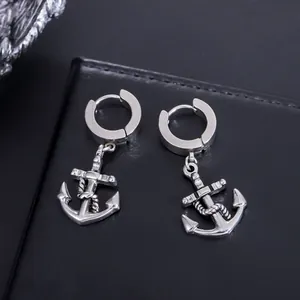 Detailed macro shot of stainless steel hoop earrings with pirate anchor pendants