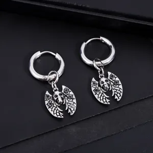 Detailed close-up of gothic stainless steel bat skull earrings on black background.