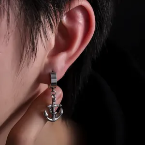 Detail view of a silver stainless steel anchor drop earring on ear for men and women