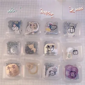 Detail view of small transparent plastic storage boxes for earrings and necklaces in a grid