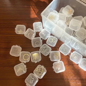 Transparent mini jewelry storage boxes for earrings and necklaces organized in a large bin
