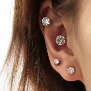 Macro view of sparkling zircon magnetic ear studs worn on various ear positions.