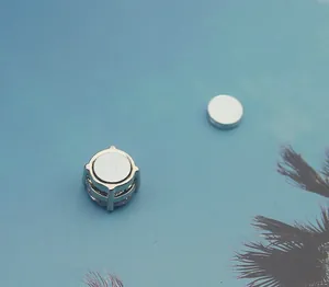 Detailed close-up showing the magnetic structure of a silver clip-on stud earring.